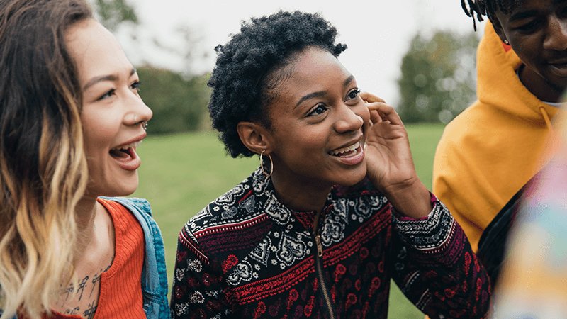 teenager friends talking outside presumably about the 1617 railcard saver